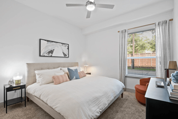 Large Bedroom with Oversized Windows and Plush Carpet at Abstract at Design District in Dallas, TX 75207