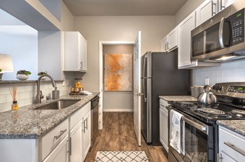 Modern Style Kitchen with Stainless-Steel Appliances and Granite Countertops at Creekside at Legacy in Plano, TX