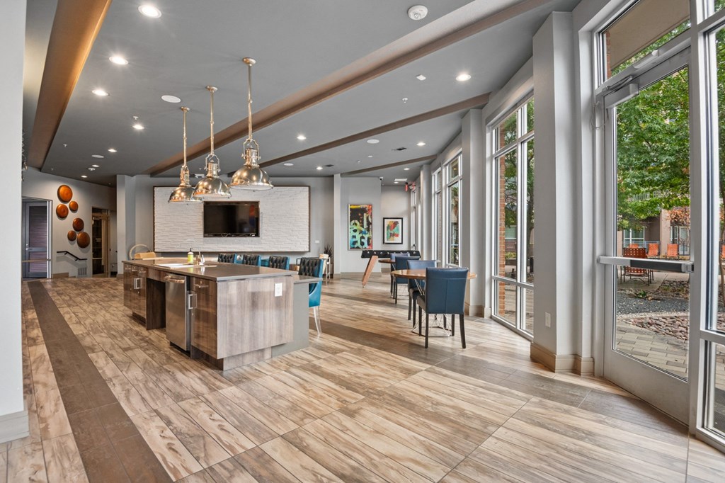 a kitchen with a large island and a dining room with a table and chairs at South Side Flats, Dallas