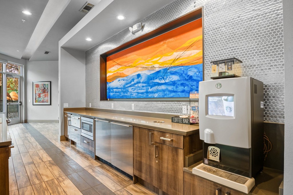 a wet bar with a refrigerator and a painting on the wall at South Side Flats, Dallas, Texas