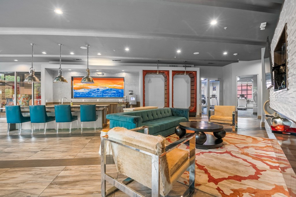 a living room with a green couch and chairs and a bar at South Side Flats, Dallas, Texas