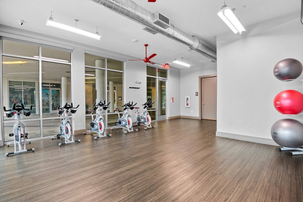 the gym with treadmills and exercise balls at the belgard apartments at South Side Flats, Dallas, 75215