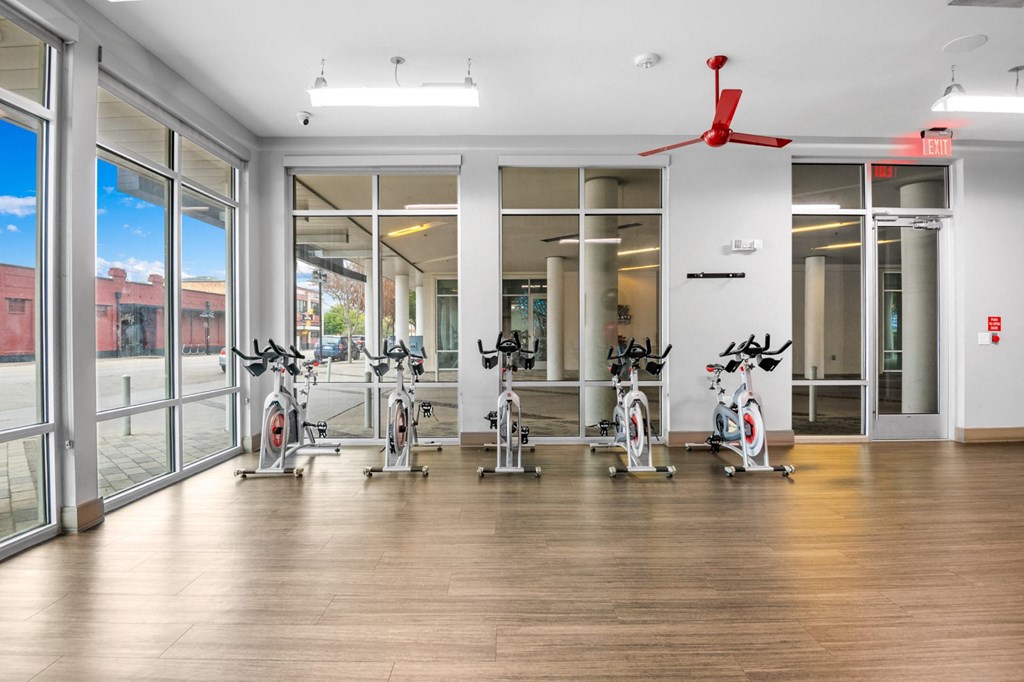 the gym with treadmills and ellipticals at the belgard apartments at South Side Flats, Dallas, TX