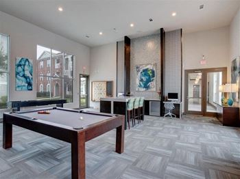 a game room with a pool table and a bar