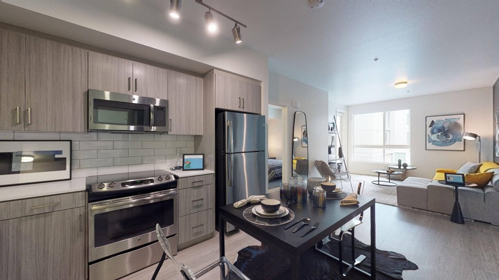 a kitchen with stainless steel appliances and a black table