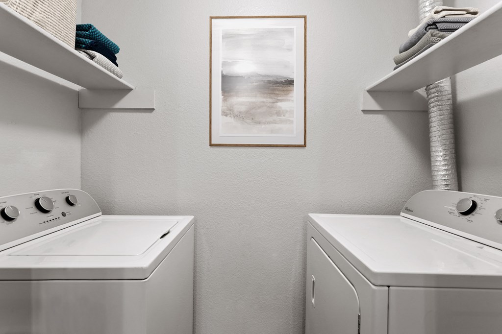 a laundry room with a washer and dryer and a painting on the wall  at Verona, Littleton, CO, 80123