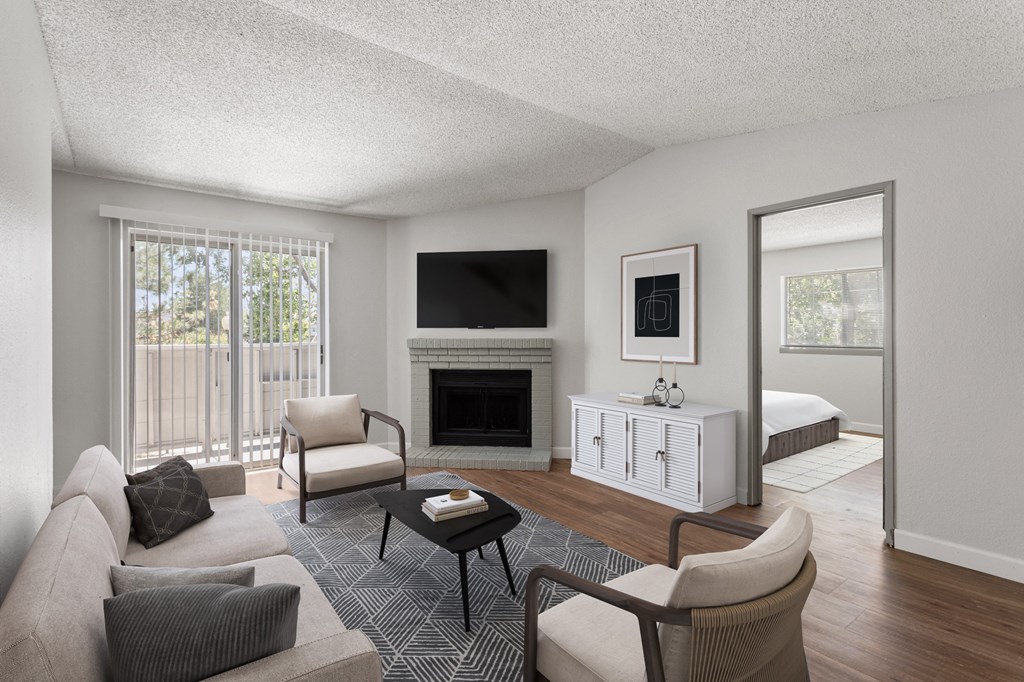 a living room with a couch and a chair and a fireplace  at Verona, Colorado, 80123