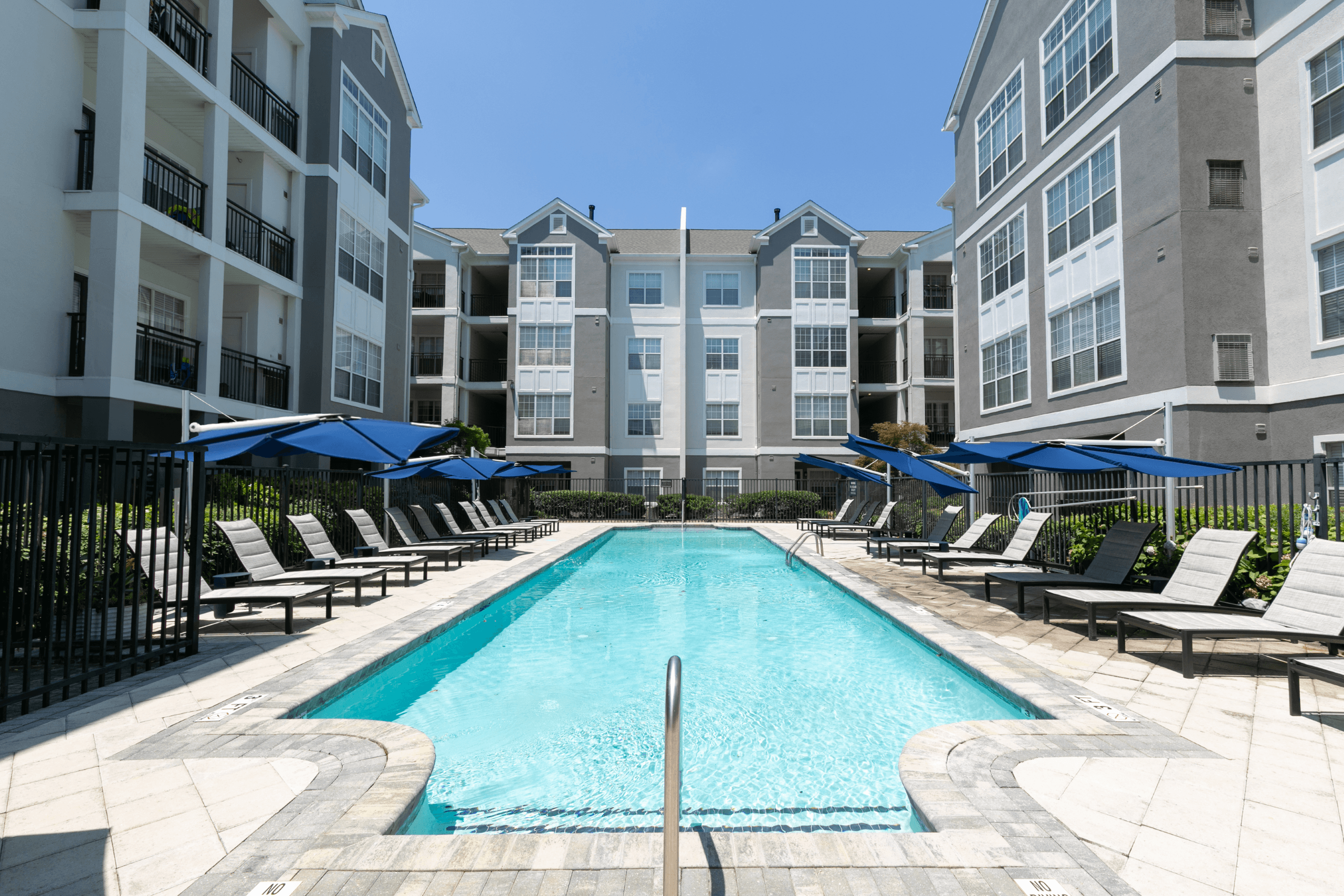 a swimming pool in front of an apartment building