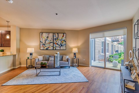 a living room with a couch and a sliding glass door to a patio
