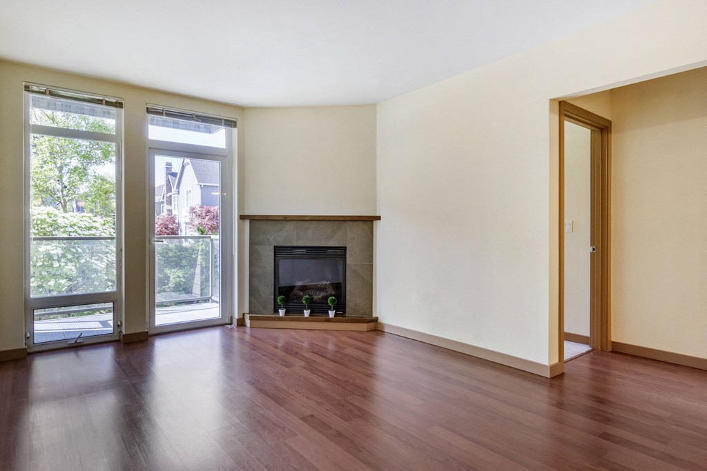 living room with hardwood floors and a fireplace  at 128 on State, Washington, 98033