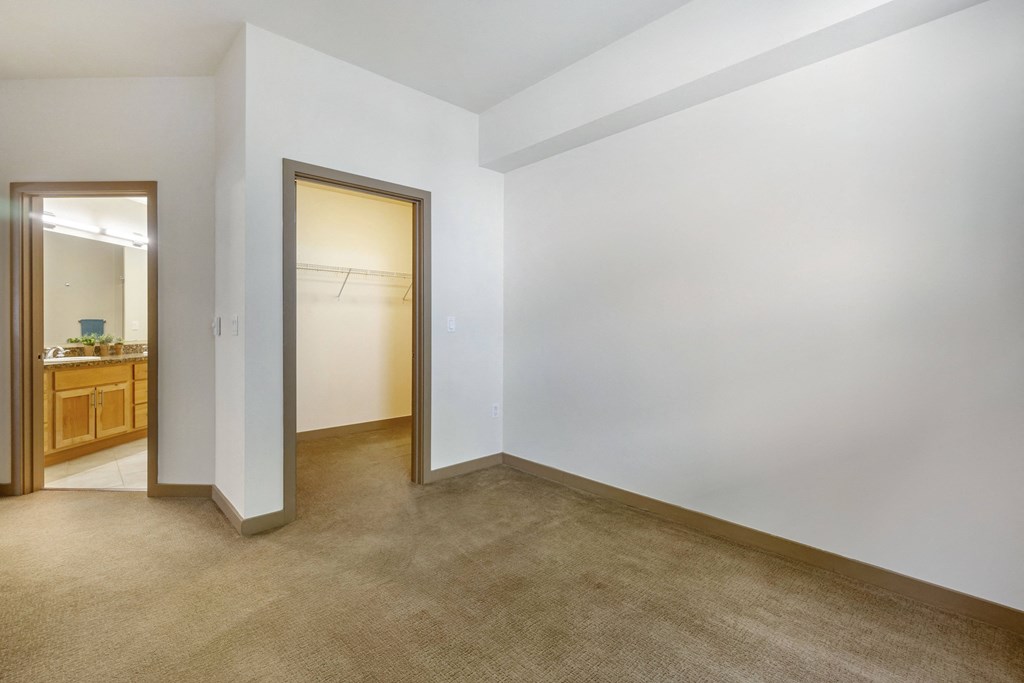 a bedroom with white walls and a carpeted floor  at 128 on State, Washington, 98033