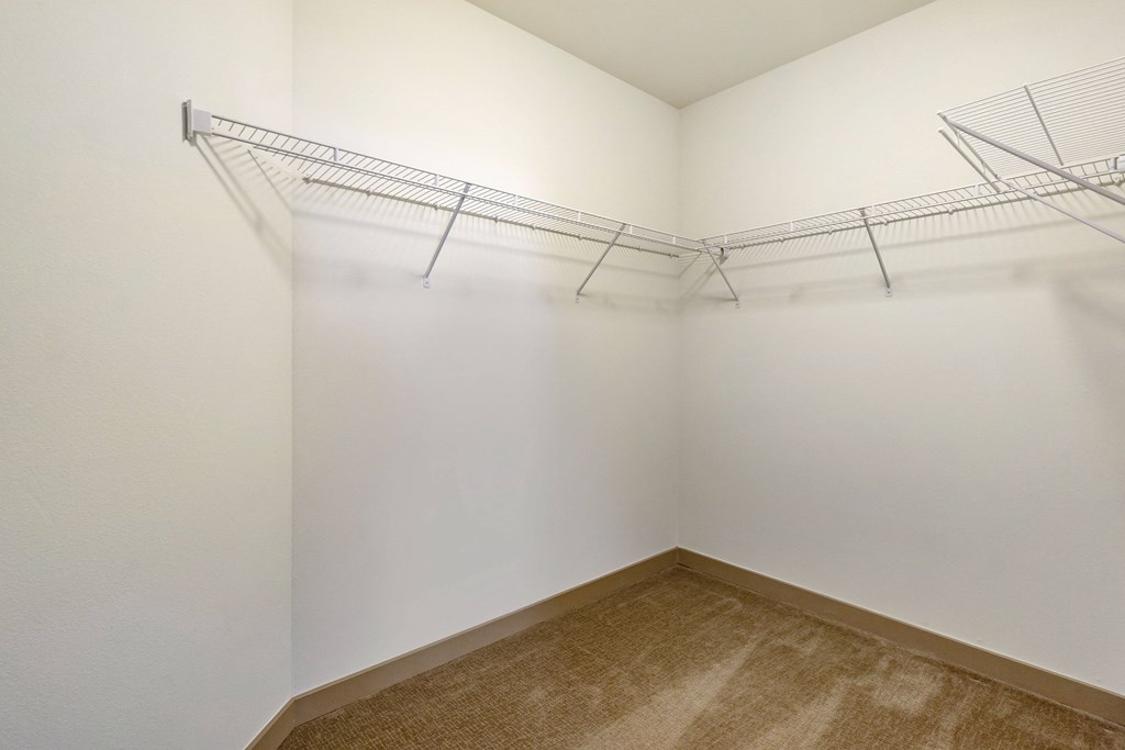 an oversized closet with white walls and built in shelving at 128 on State, Kirkland