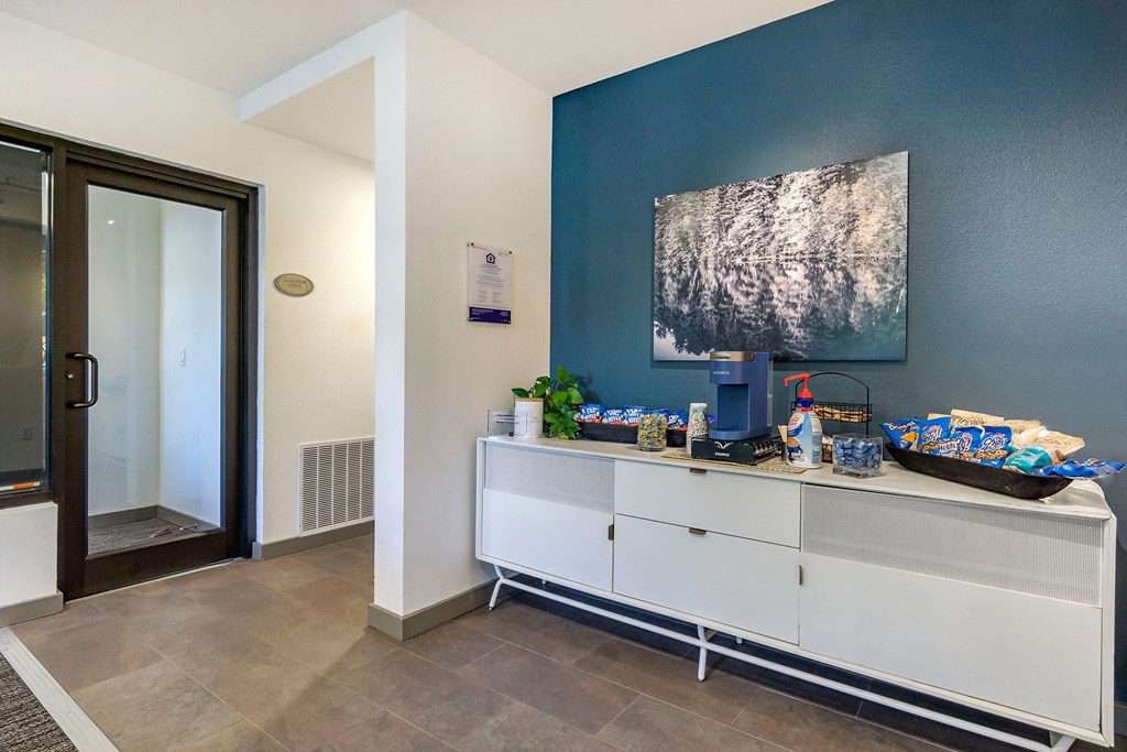 resident coffee station with a blue wall and an elegant white cabinet at 128 on State, Washington, 98033
