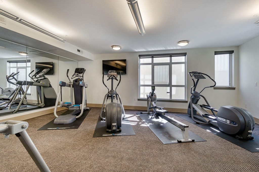 fully equipped fitness room with cardio equipment at 128 on State, Washington