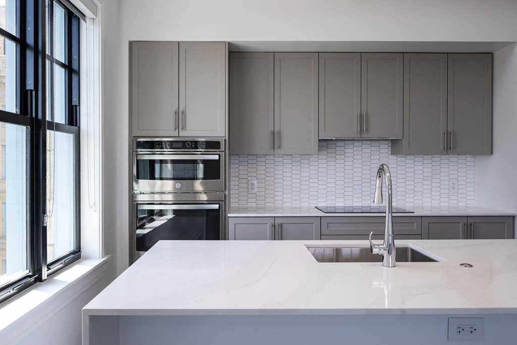 a kitchen with white counter tops and stainless steel appliances  at The Belden Stratford, Chicago, Illinois
