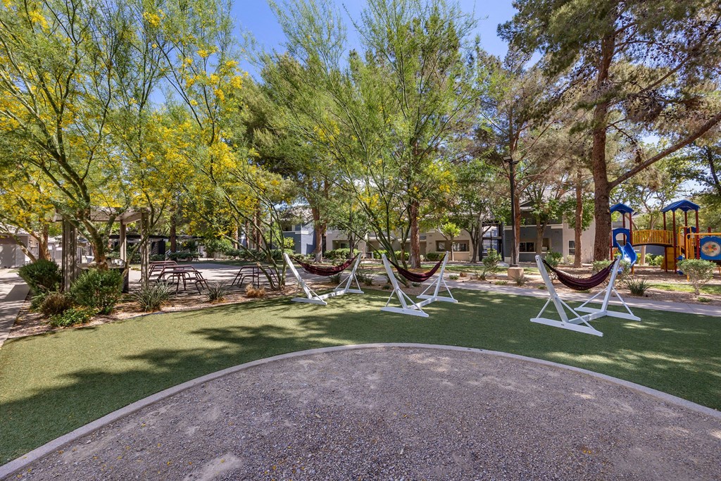 a group of hammocks in a park with a playground at Paisley and Pointe Apartments, Las Vegas, 89130