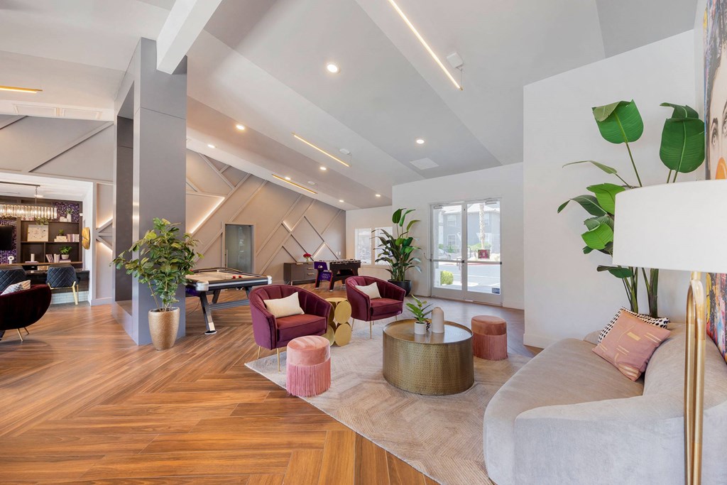 a living room with furniture and a pool table at Paisley and Pointe Apartments, Nevada