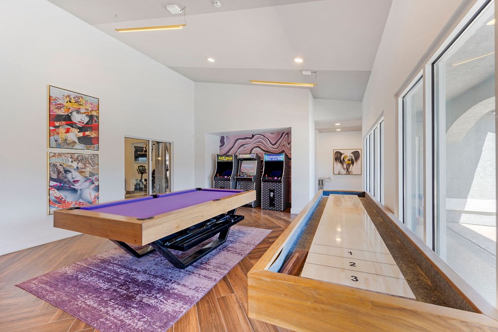a game room with a pool table and other games in it at Paisley and Pointe Apartments, Las Vegas, 89130