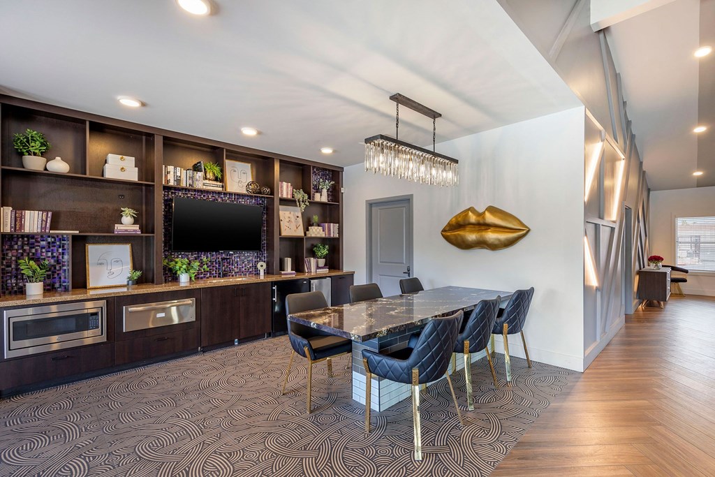 a dining room with a table and chairs and a tvat Paisley and Pointe Apartments, Las Vegas