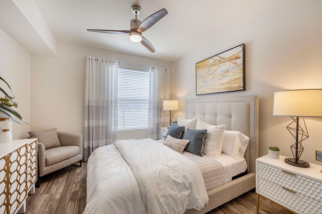 a bedroom with a large bed and a ceiling fan at Paisley and Pointe Apartments, Las Vegas, NV 89130