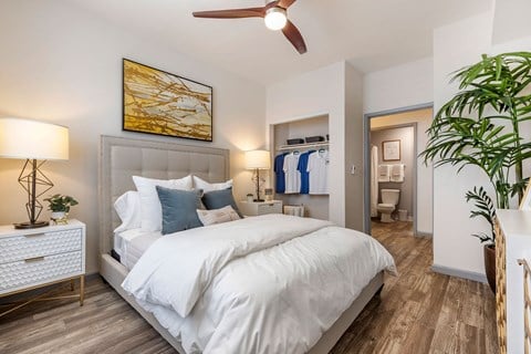 a bedroom with a white bed and a ceiling fan at Paisley and Pointe Apartments, Nevada, 89130