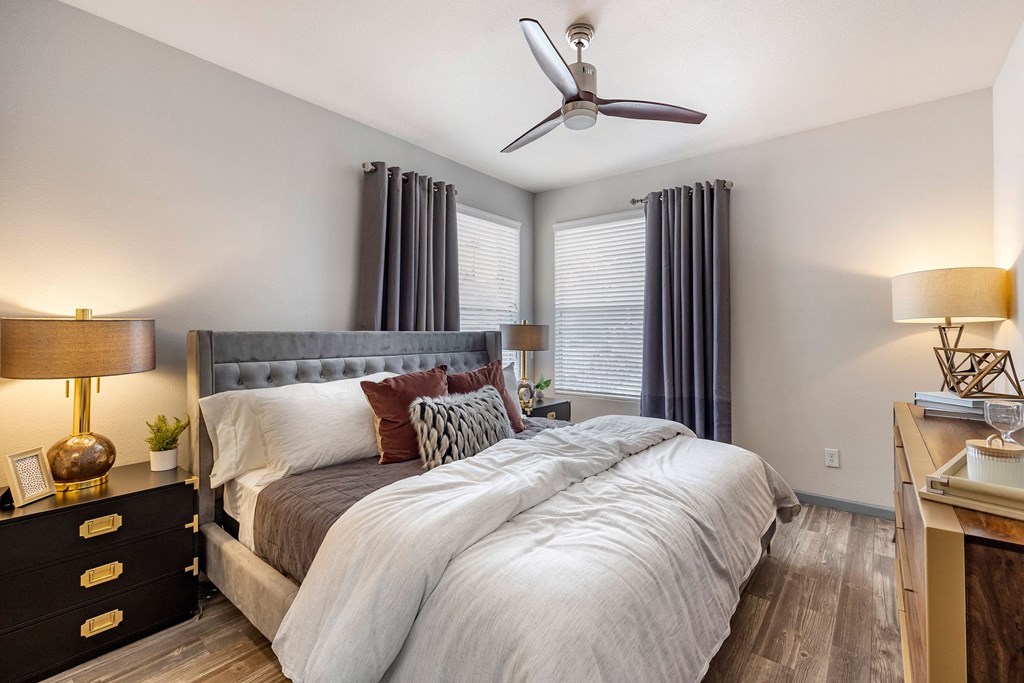 a bedroom with a large bed and a ceiling fan at Paisley and Pointe Apartments, Las Vegas, 89130
