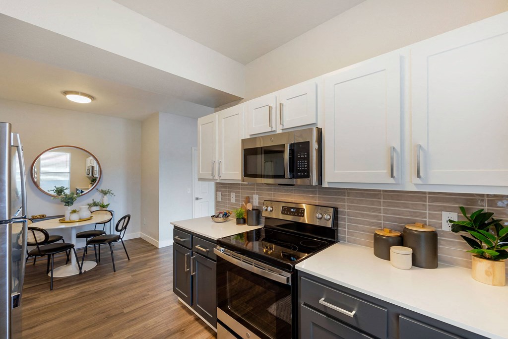 a kitchen with stainless steel appliances and white cabinets at Paisley and Pointe Apartments, Las Vegas, NV 89130