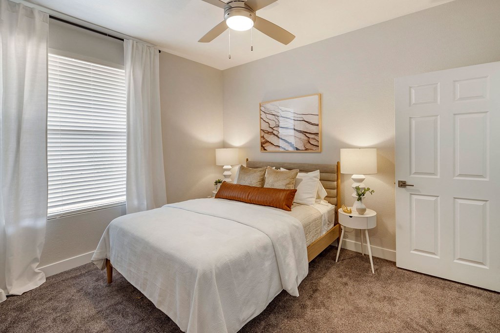 a bedroom with a bed and a ceiling fan at Paisley and Pointe Apartments, Las Vegas, NV