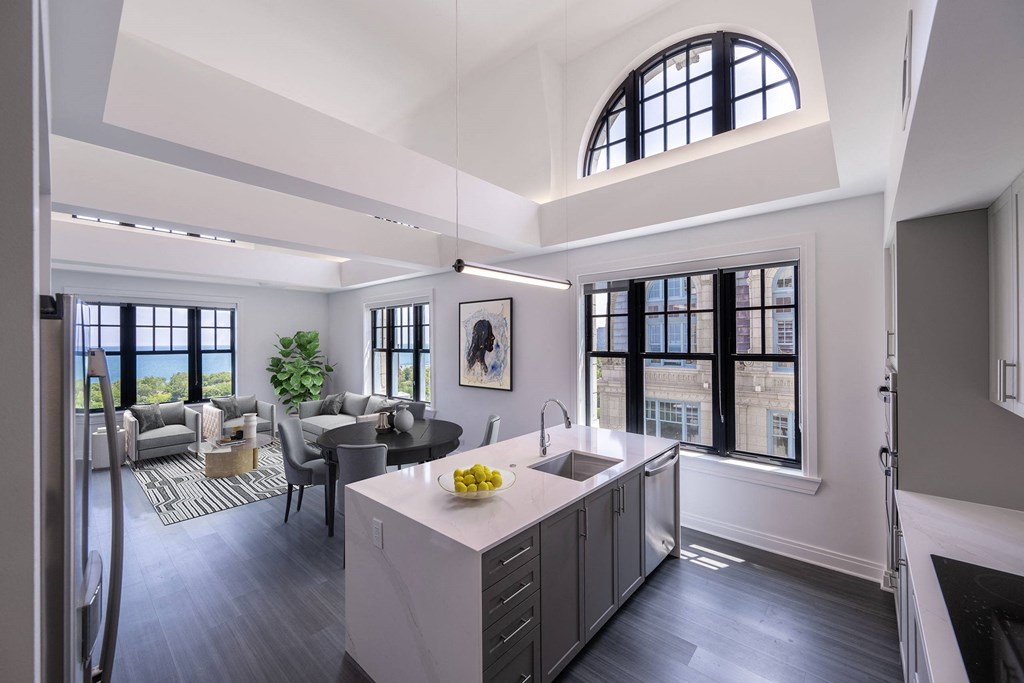 a kitchen and living room with a large arched window  at The Belden Stratford, Chicago