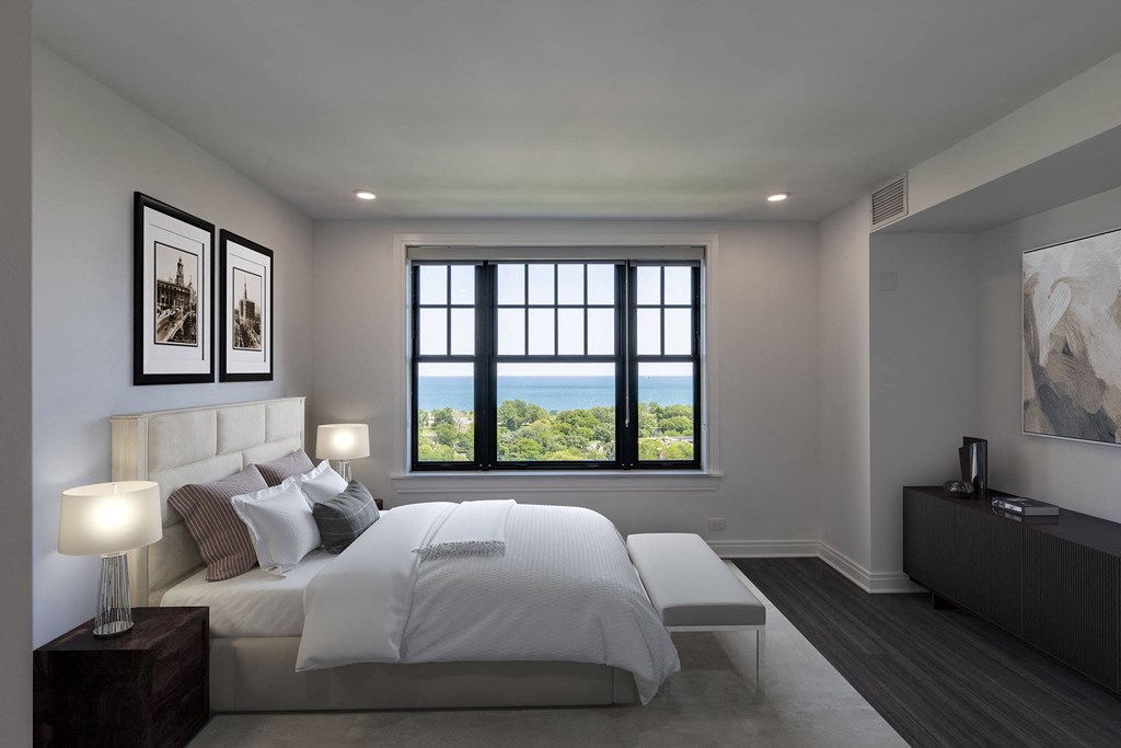 a white bedroom with a large bed and a window  at The Belden Stratford, Chicago, IL