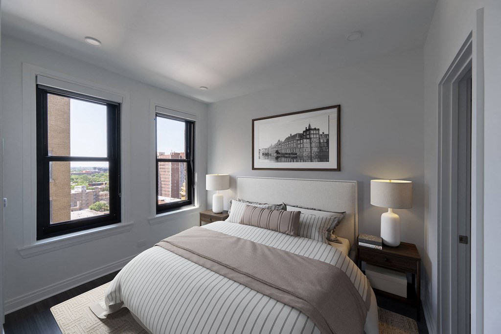 a bedroom with a bed and two windows  at The Belden Stratford, Chicago, Illinois