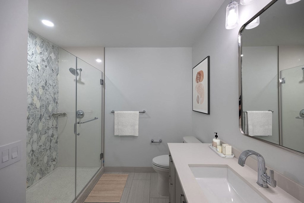 a bathroom with a shower and a sink and a mirror  at The Belden Stratford, Chicago, Illinois
