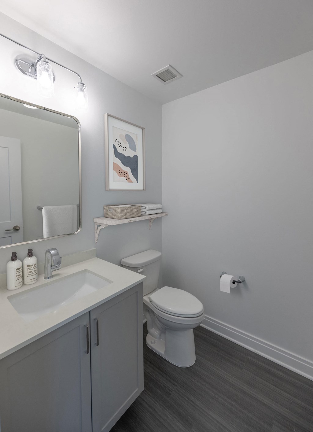 a bathroom with a toilet and a sink and a mirror at The Belden Stratford, Chicago, IL, 60614