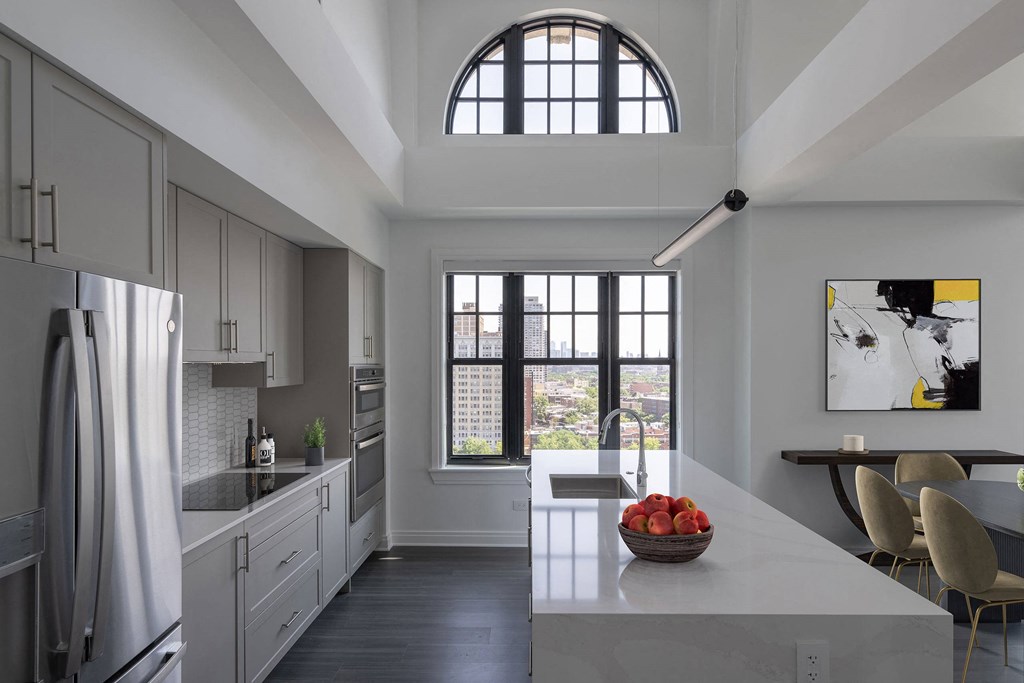 a kitchen with a large window and a table with chairs  at The Belden Stratford, Illinois, 60614