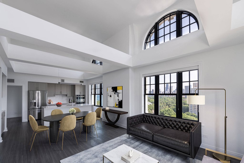 a living room with a couch and a table with chairs  at The Belden Stratford, Chicago, IL