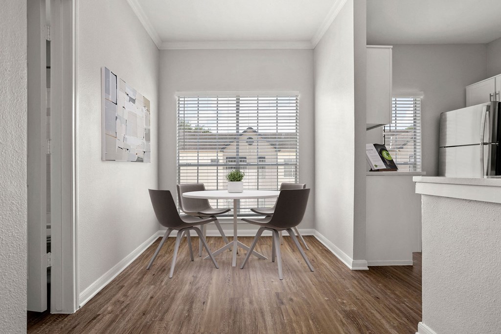 a dining room with a table and chairs and a window at Aston at Cinco Ranch, Katy