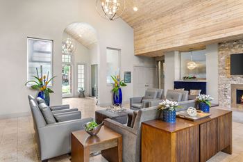 a living room with couches and tables and a fireplace at Aston at Cinco Ranch in Katy, Texas 77450