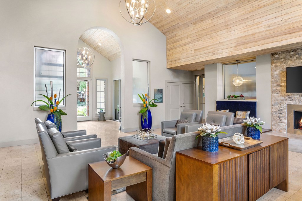 a living room with couches and tables and a fireplace at Aston at Cinco Ranch, Texas