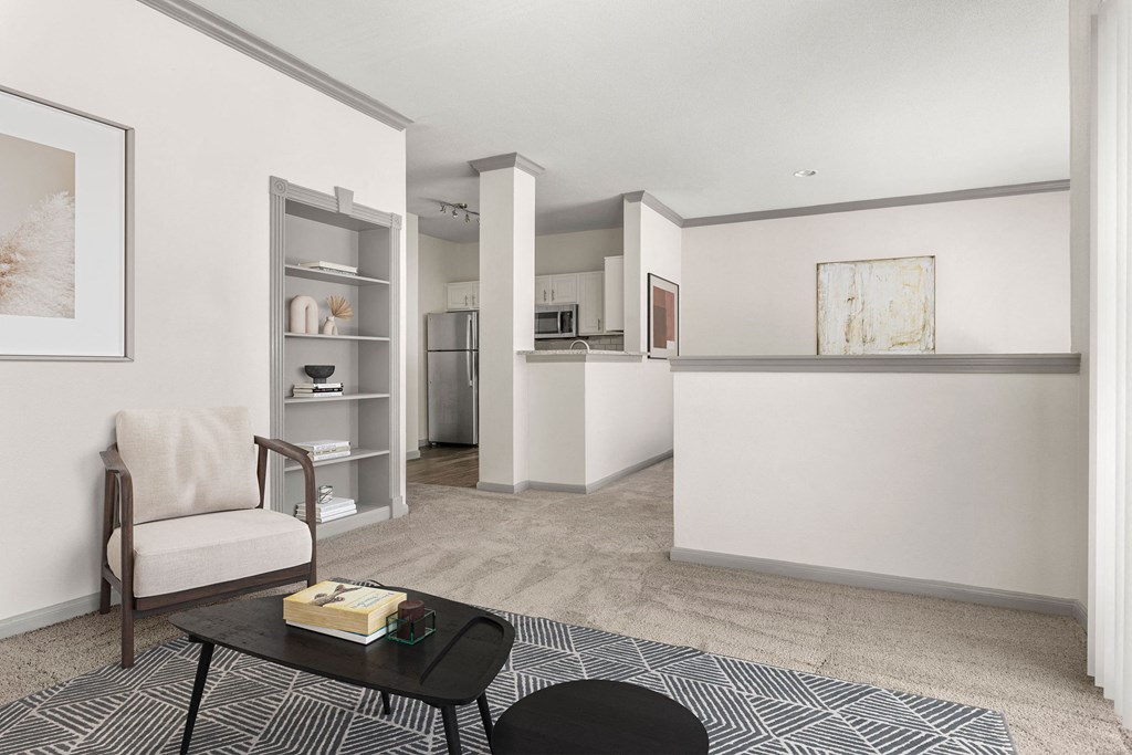 a living room with a couch and a chair and a kitchen at Aston at Cinco Ranch, Katy