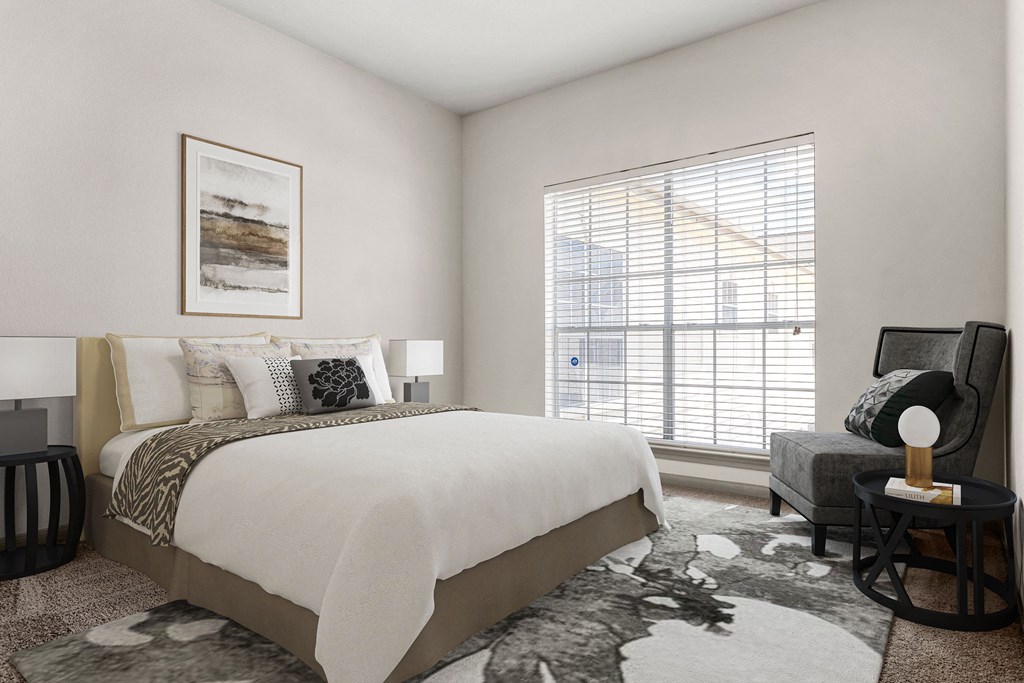 a bedroom with a large bed and a large window