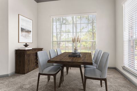 a dining room with a table and chairs and a window
