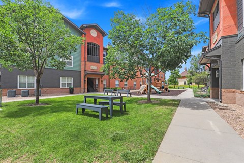 our apartments have a spacious courtyard with picnic tables at Apartments at Switchback on Platte Apartments, Littleton