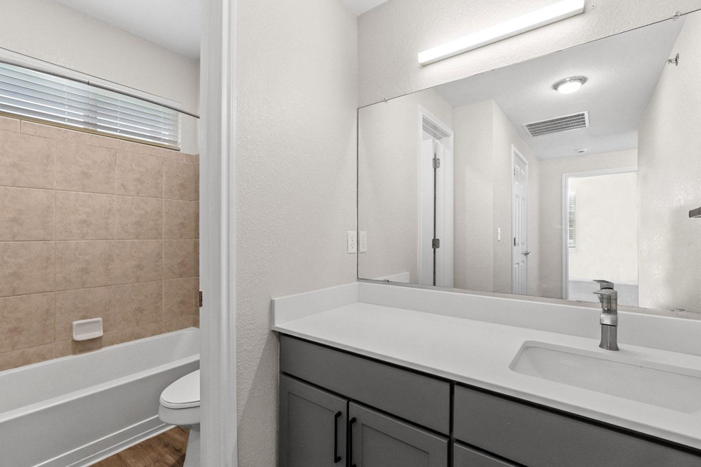 bathroom with sink and mirror at Switchback on Platte Apartments, Colorado, 80120