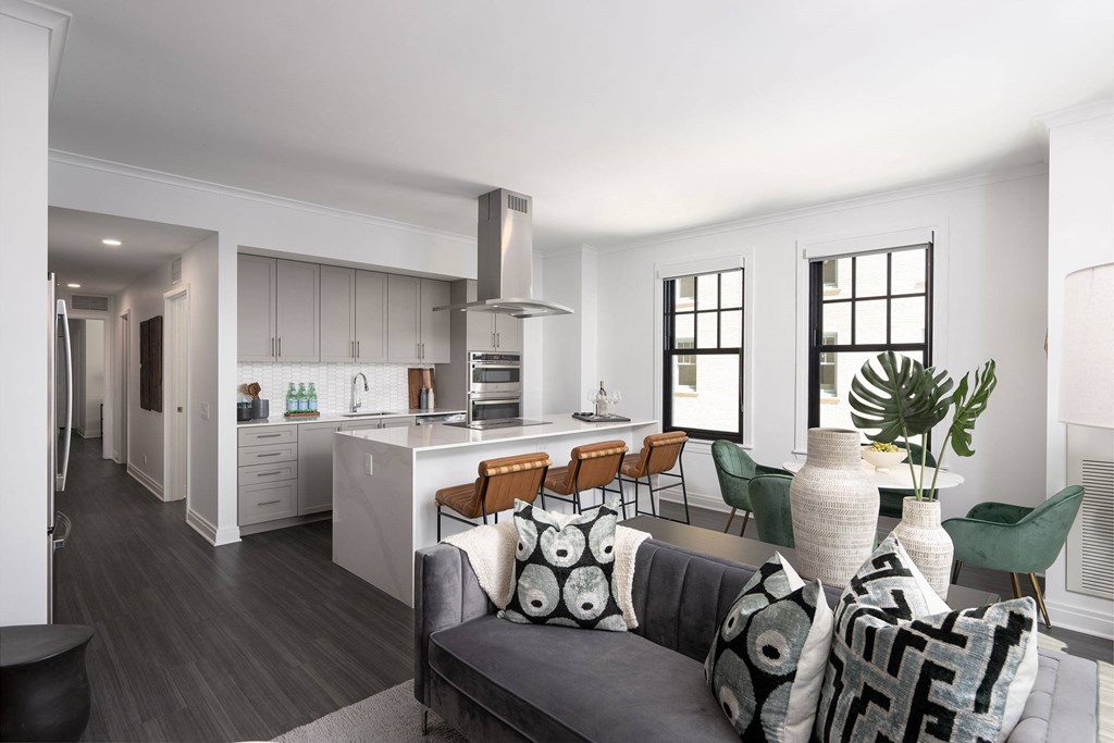 the living room and kitchen of an apartment with a couch and a table  at The Belden Stratford, Chicago, 60614