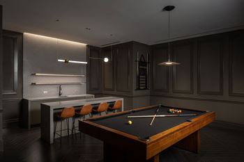 a dark room with a pool table and a bar  at The Belden Stratford, Illinois, 60614