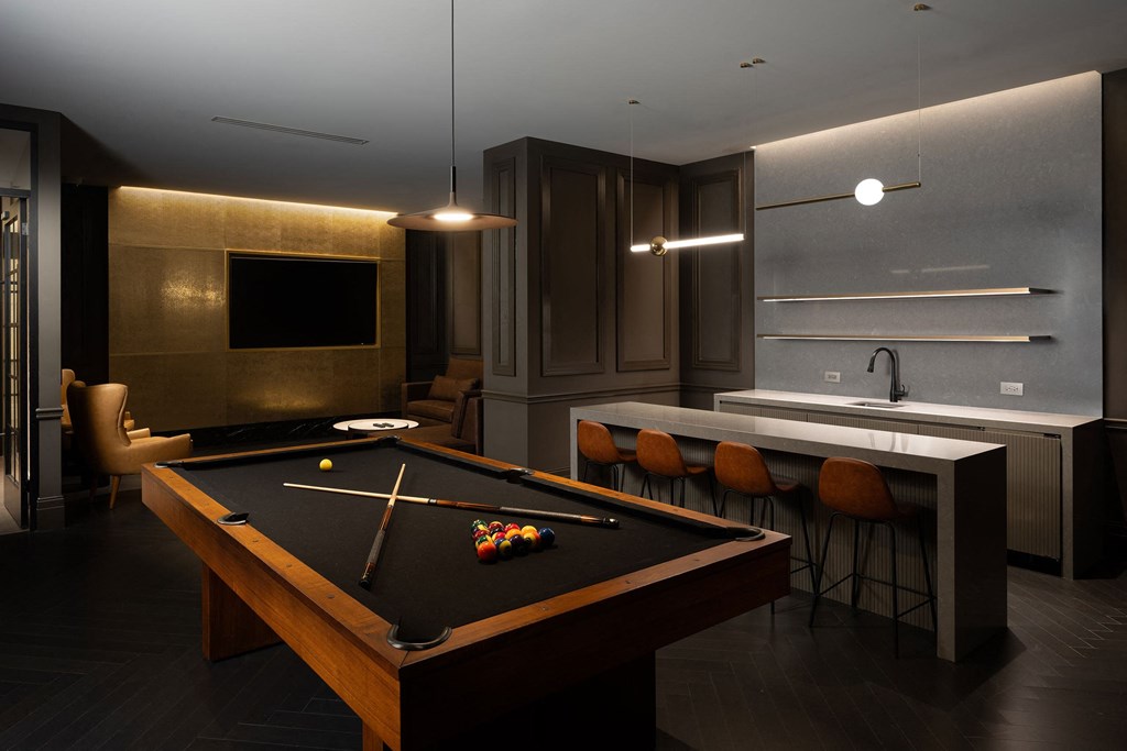 a dark room with a pool table and a bar  at The Belden Stratford, Illinois, 60614