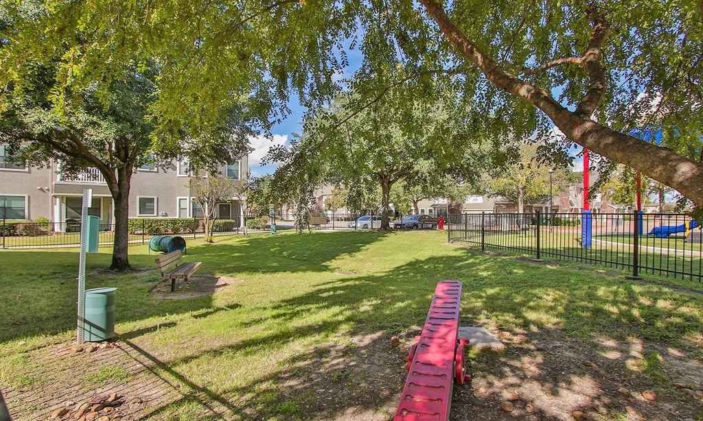 a park with a red picnic table and benches at Sladestone Shadow Creek, Pearland, TX