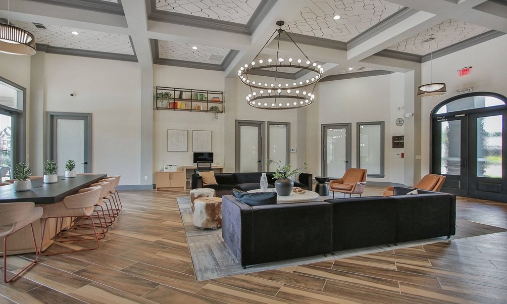 a large living room with a large chandelier and a table and chairs at Sladestone Shadow Creek, Texas