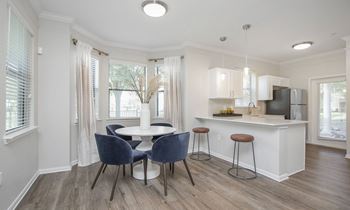 a living room with a kitchen and a table and chairs at Sladestone Shadow Creek, Texas, 77584