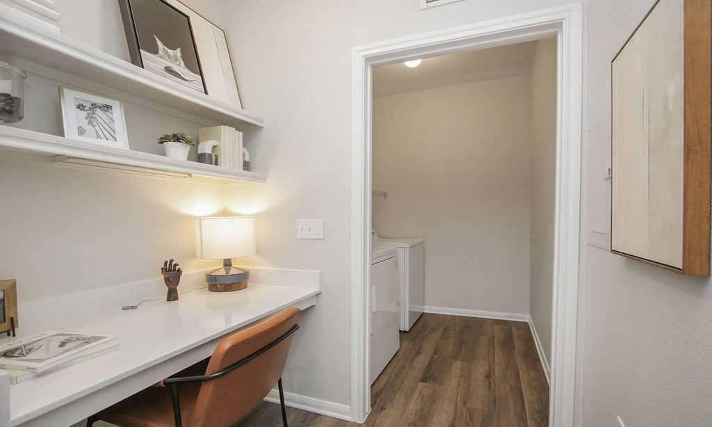 a home office with a desk and a hallway to a bathroom at Sladestone Shadow Creek, Texas